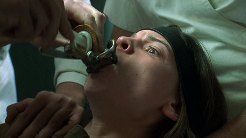 Literal control of women in prison allegorically representing how women are controlled in every day life